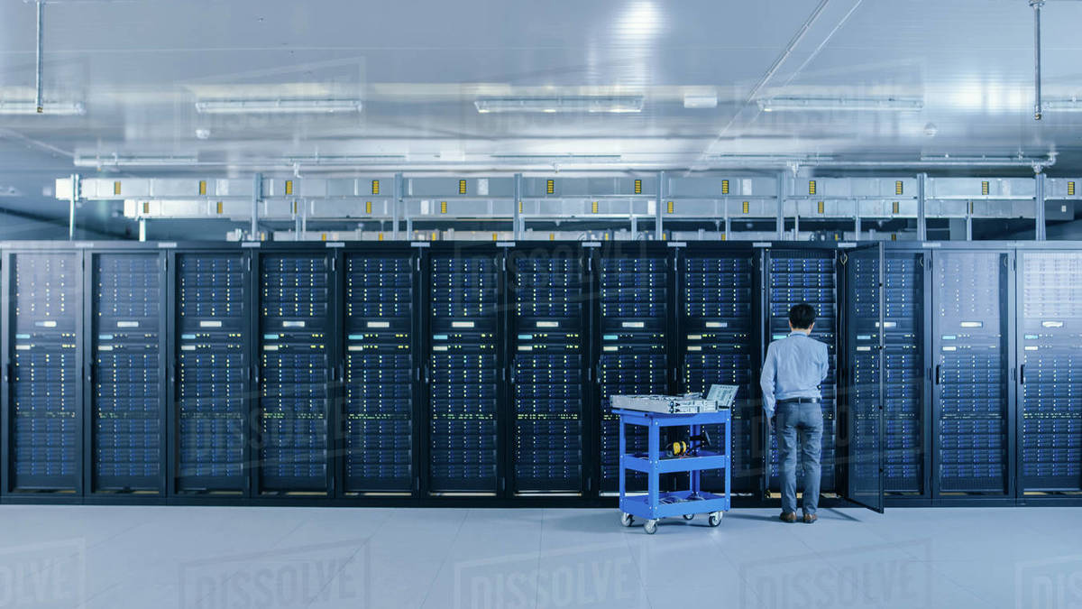 In the Data Center IT Engineer Working with Server Racks Works with