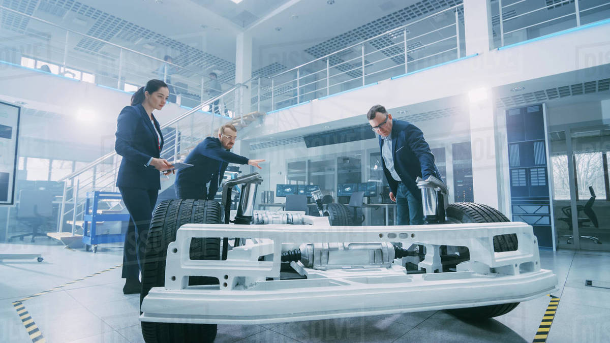 Automotive Design Engineers Talking while Working on Electric Car