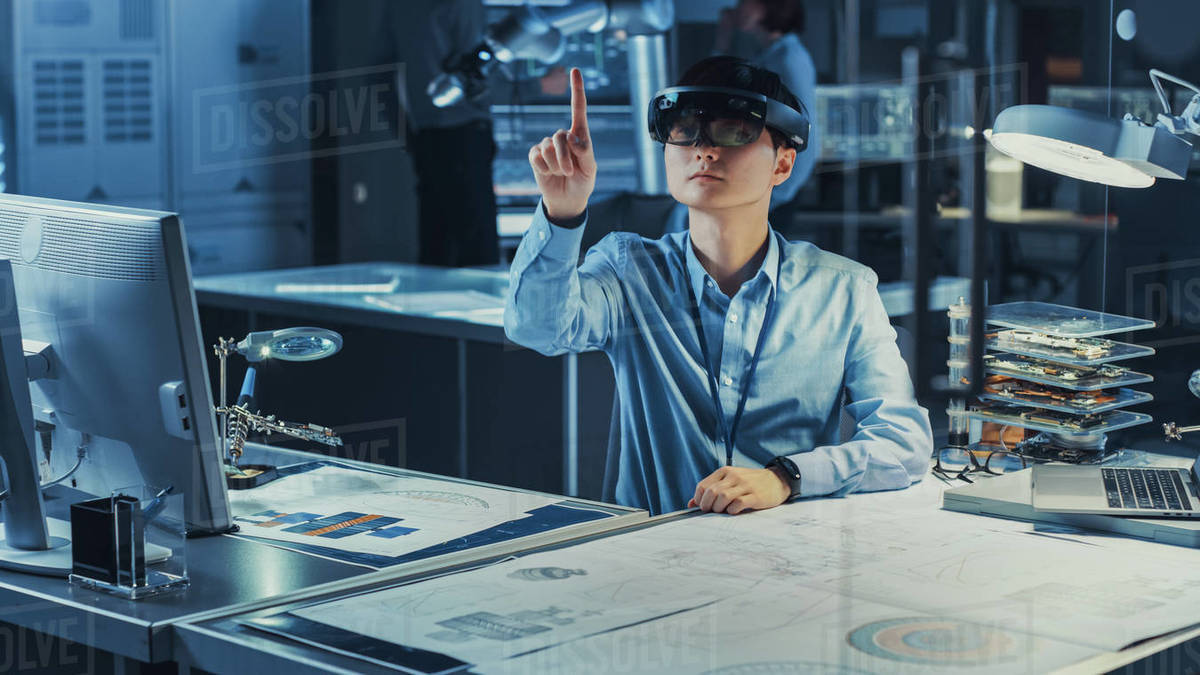 Professional Japanese Development Engineer is Working in a AR Headset, Making Gestures of Moving