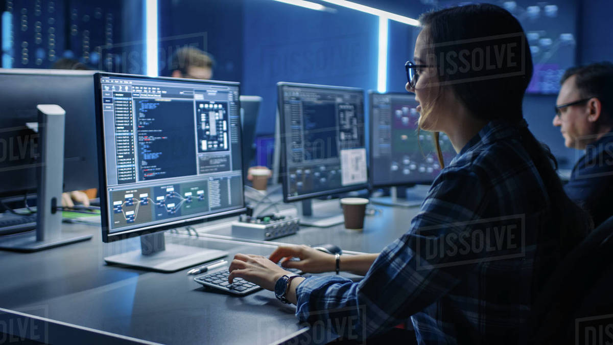 Smart Female IT Programer Working on Desktop Computer in Data Center ...