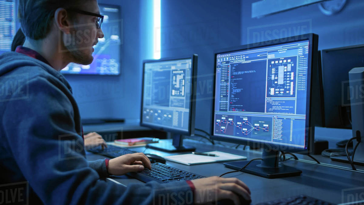 Smart Male IT Programer Working on Desktop Computer. Software