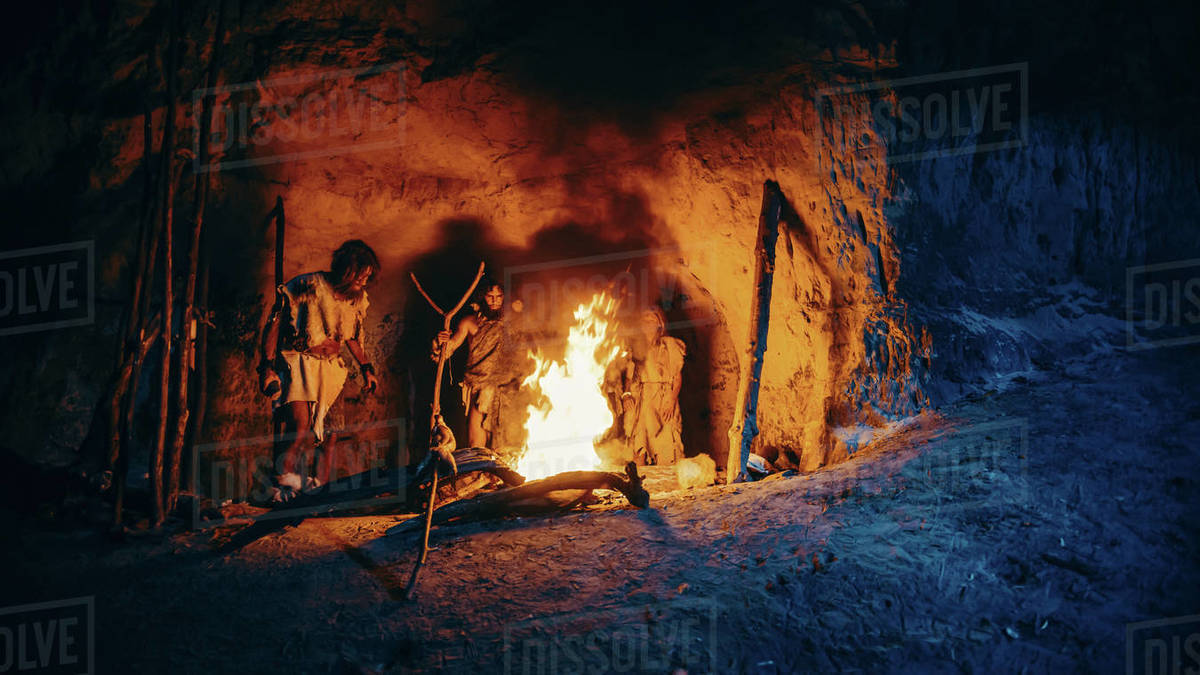 Tribe of Prehistoric Hunter-Gatherers Wearing Animal Skins Stand Around ...