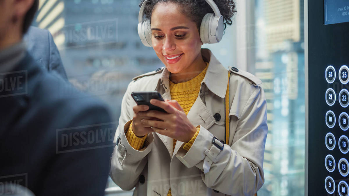 Beautiful Black Female Riding Glass Elevator to Office in Modern
