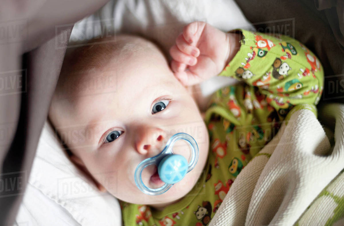 Baby boy with pacifier Stock Photo Dissolve