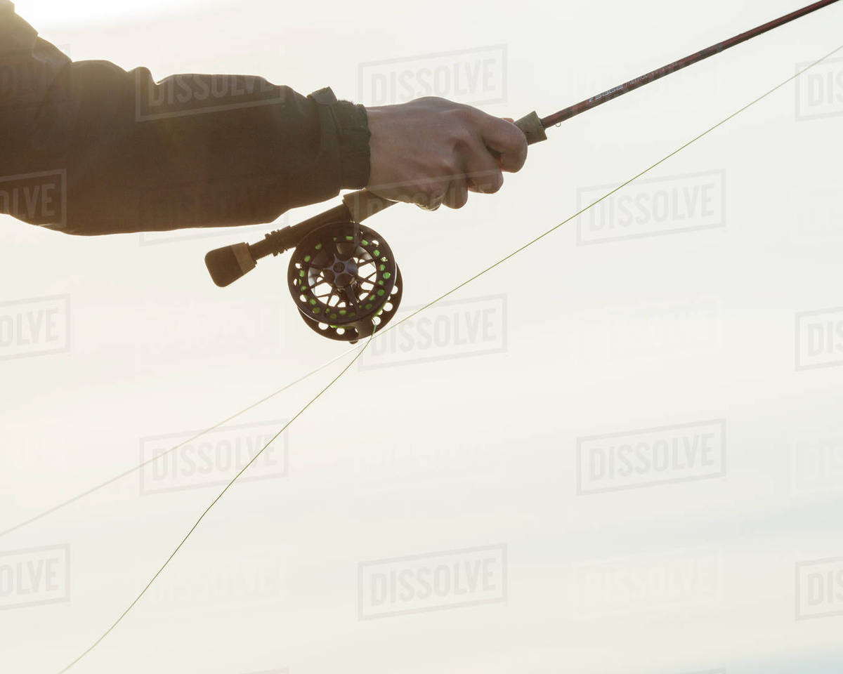 Hand holding fishing rod - Royalty-free Stock Photo | Dissolve