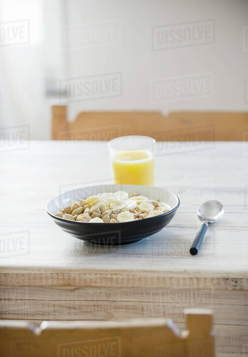 Cereals with banana in bowl Stock Photo Dissolve