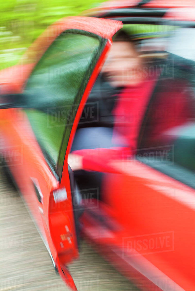 Person leaving car Stock Photo Dissolve