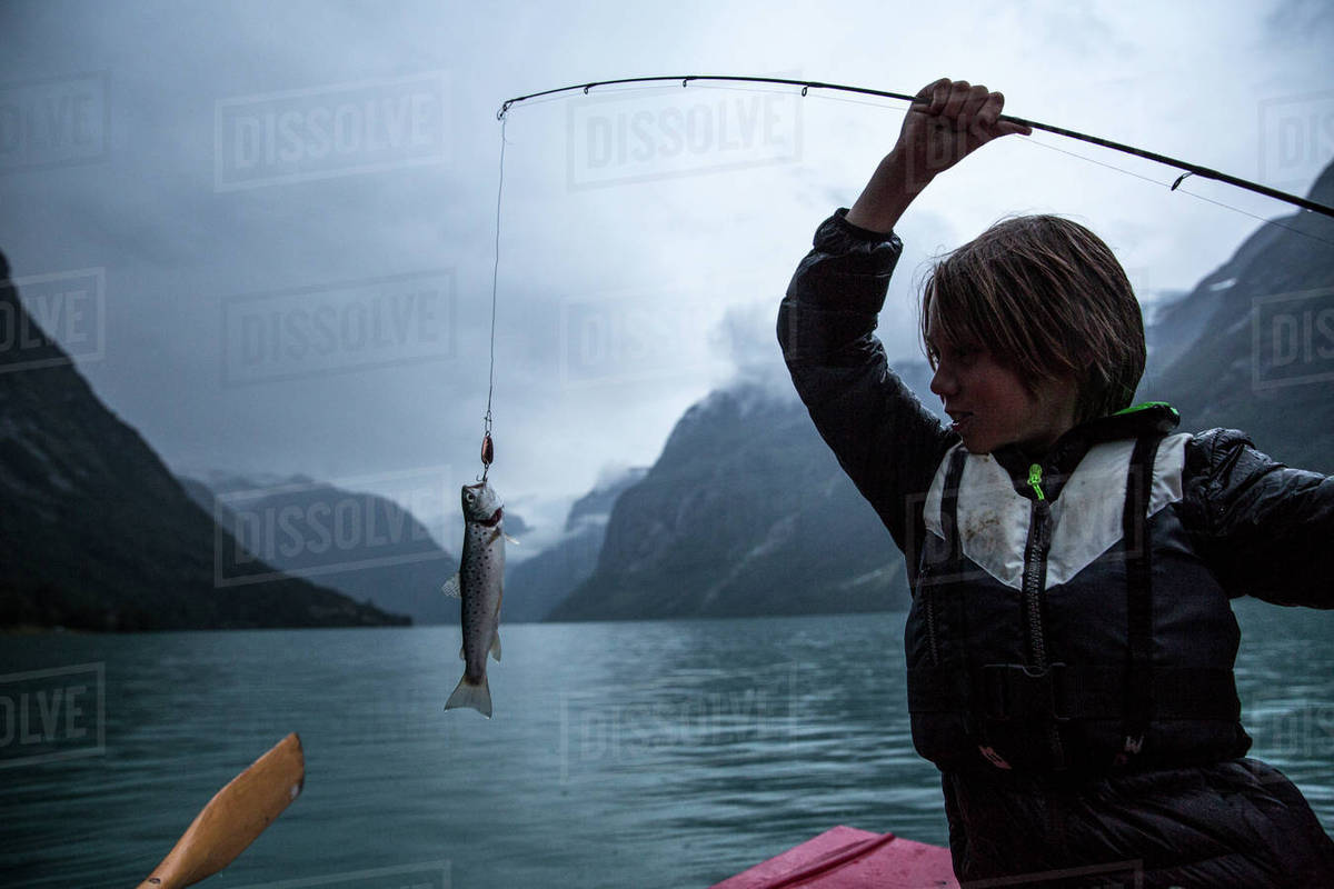 Boy With Fish On Hook Stock Photo Dissolve