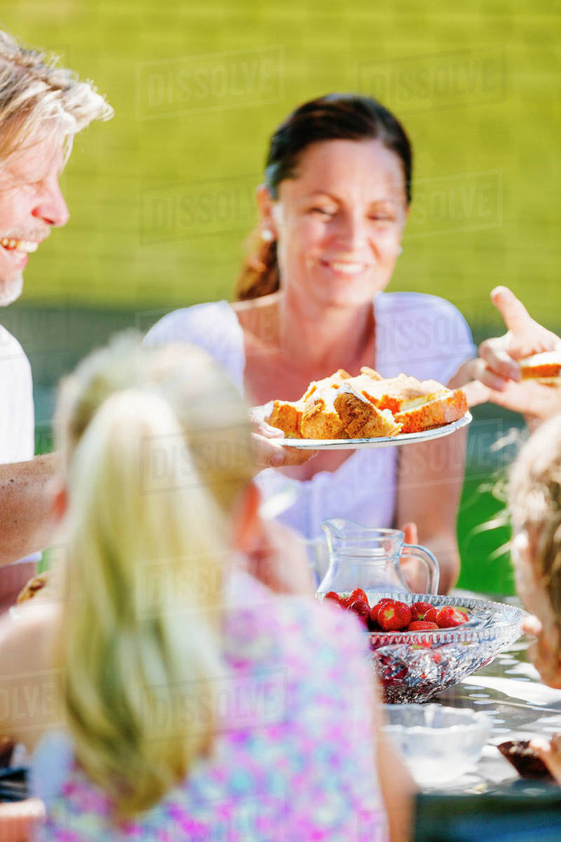 Family sharing food at party Stock Photo Dissolve