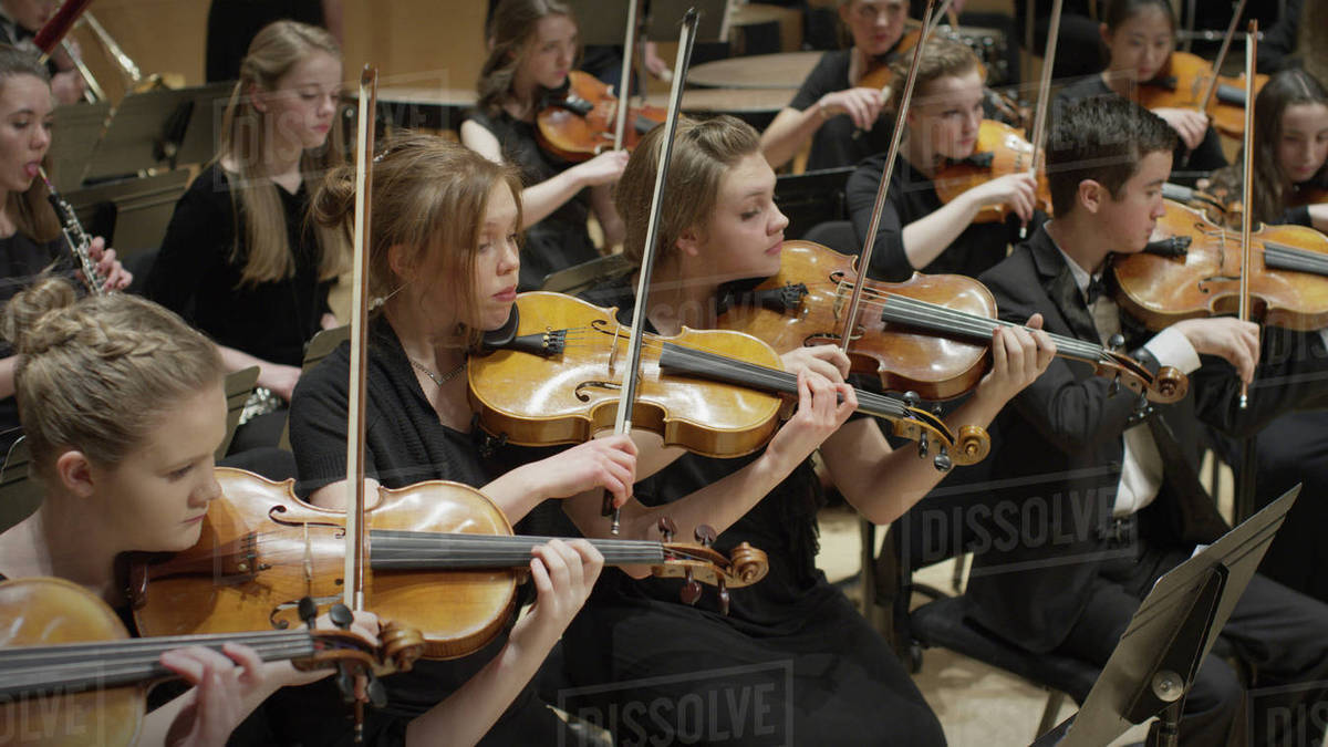 High angle view of student musicians playing violins in orchestra