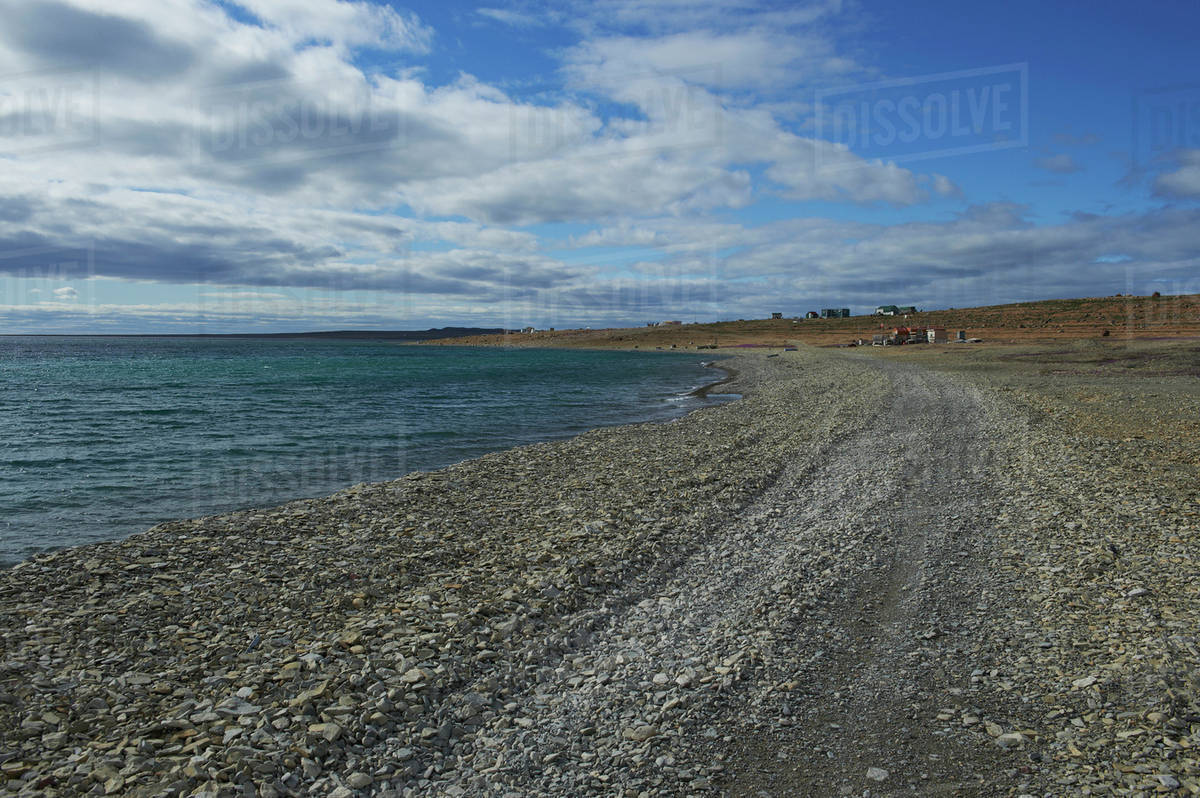 Shoreline along Cambridge bay, with buildings and tundra in the