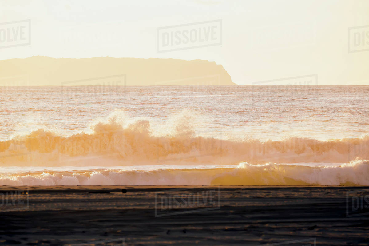 Golden surf visible from Barking Sands Beach in Kekaha with Niihau