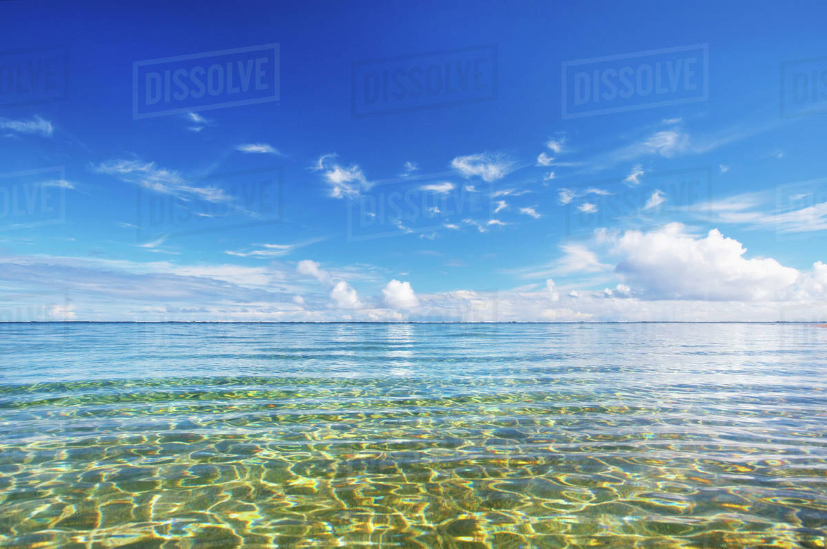 Clear water of the pacific ocean with blue sky and cloud; Kauai, Hawaii