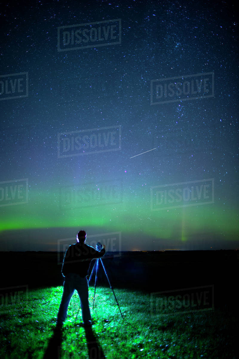 A photographer captures the Northern lights and shooting star, near