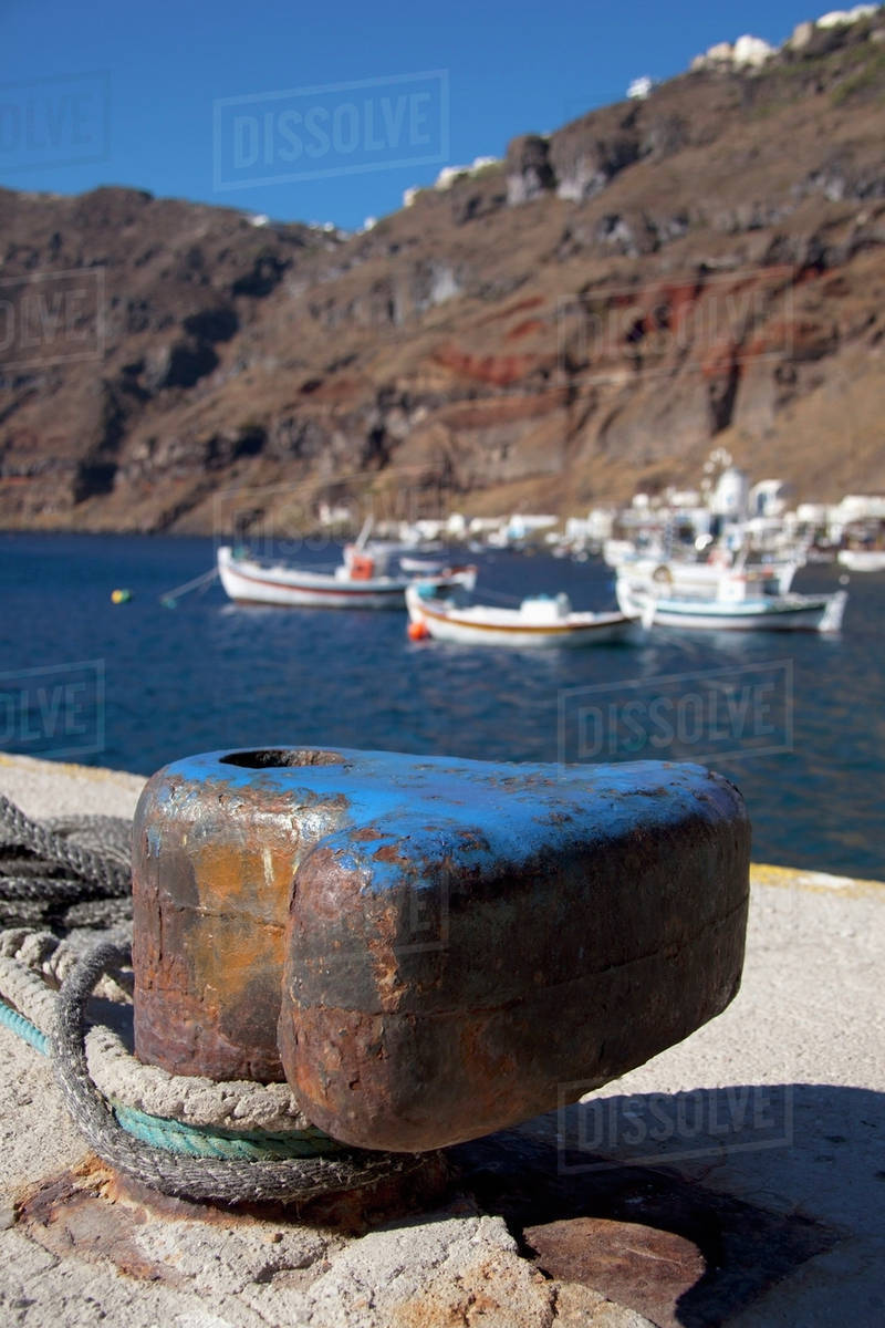 Ropes tied at shore and boats mooring in the harbour;Manola greece