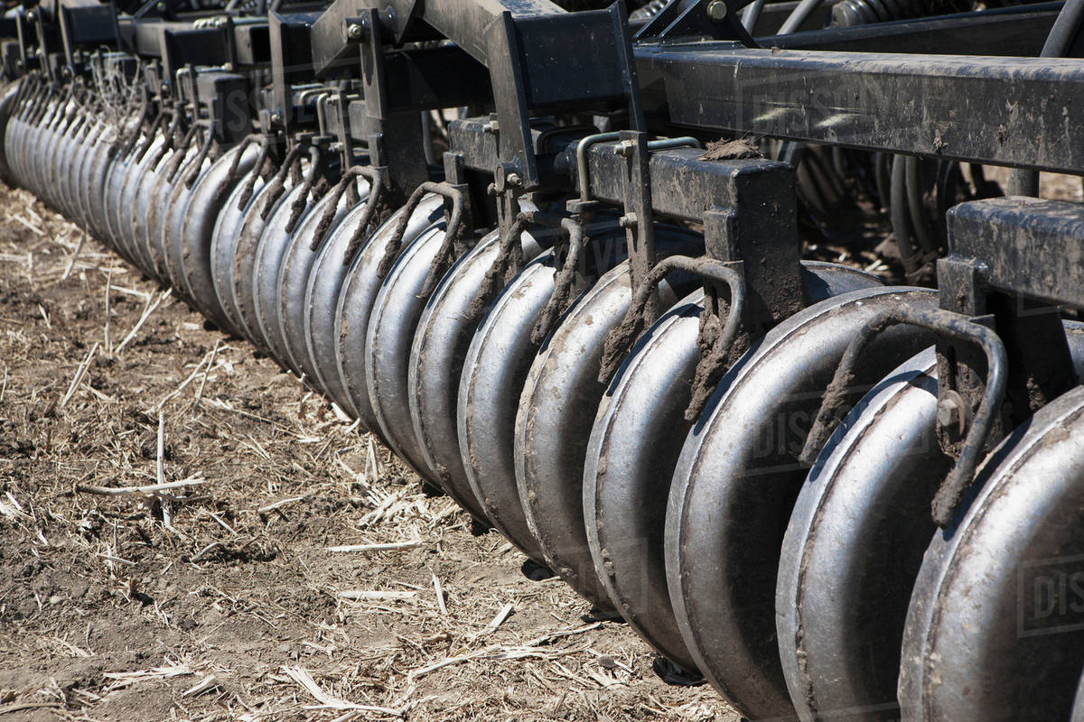 Close up of a series of rollers on an air seeder;Alberta Canada Stock