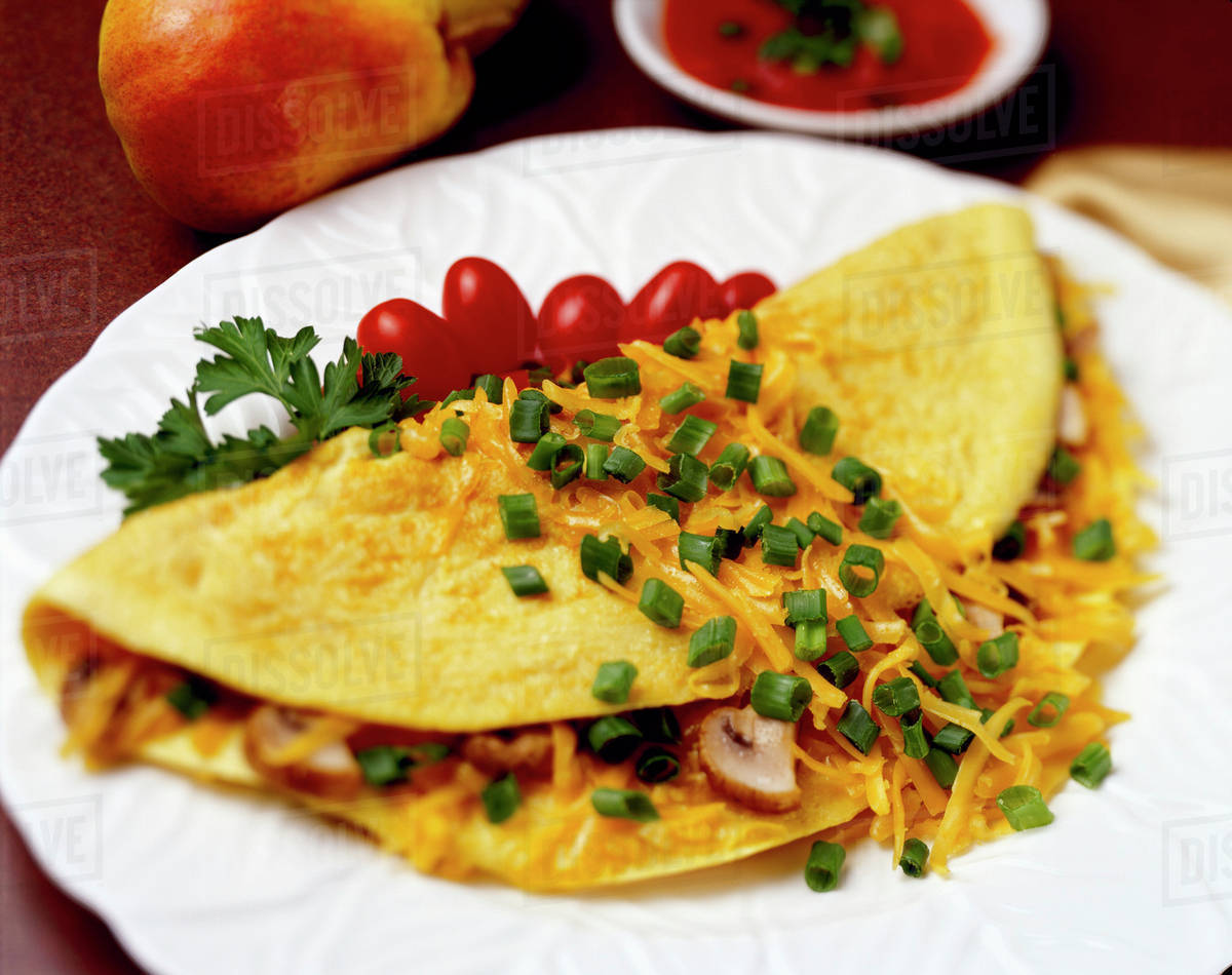Food Cheese and Mushroom Omelette garnished with chopped green onions