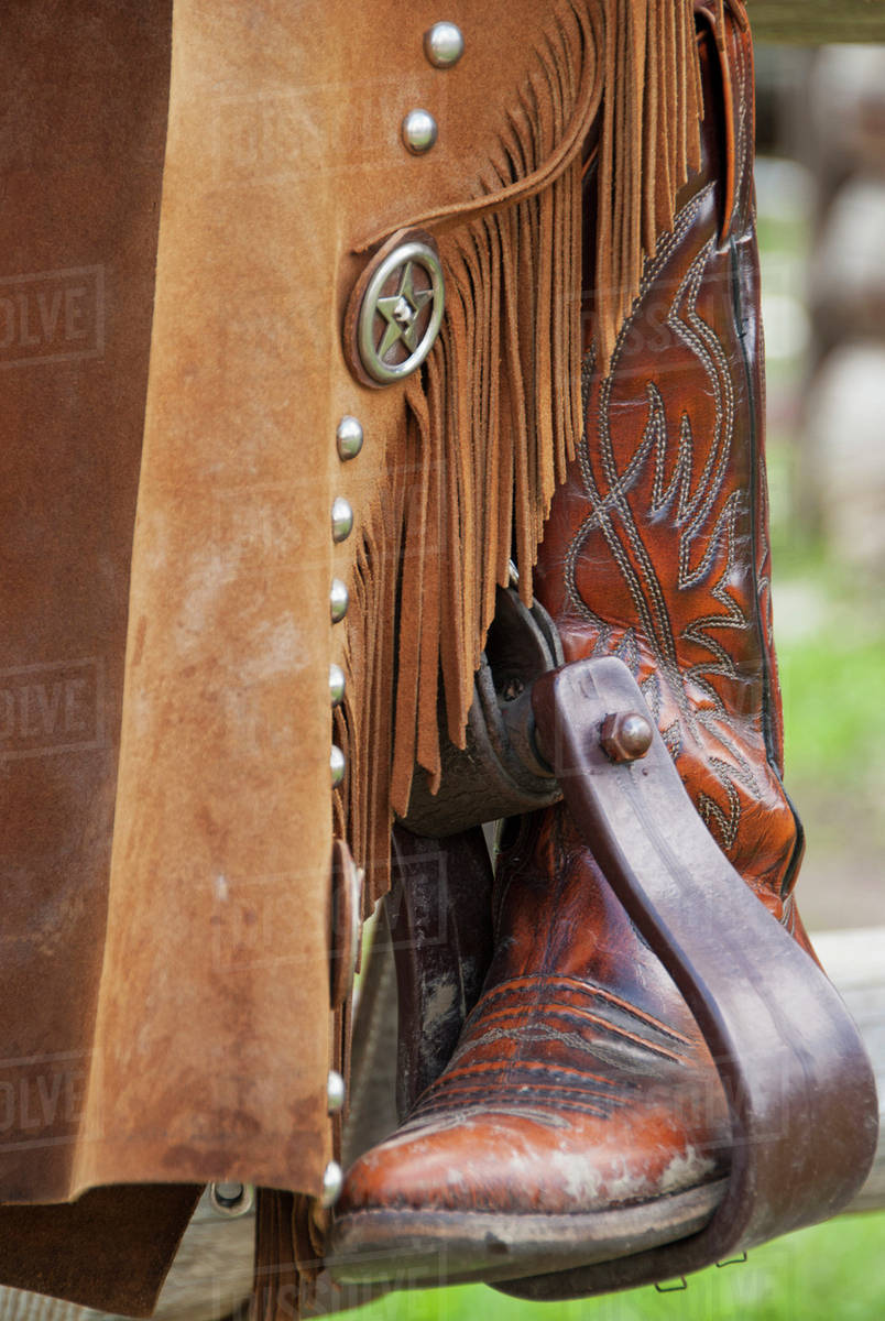 Closeup of a cowboy boot in the stirrups; Alberta, Canada Stock