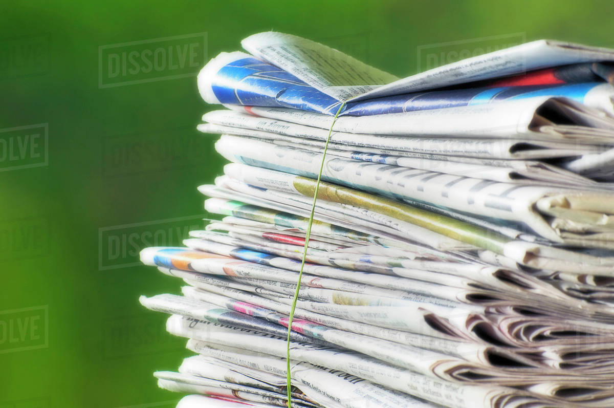 Newspapers Tied Into A Pile For The Recycle Bin. Stock Photo Dissolve