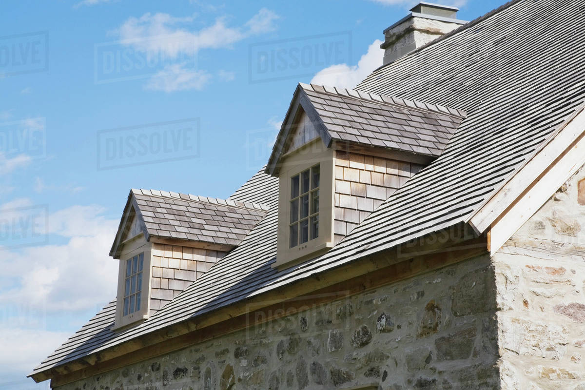 View Of The Cedar Shingles Roof And Dormer Windows On An Old