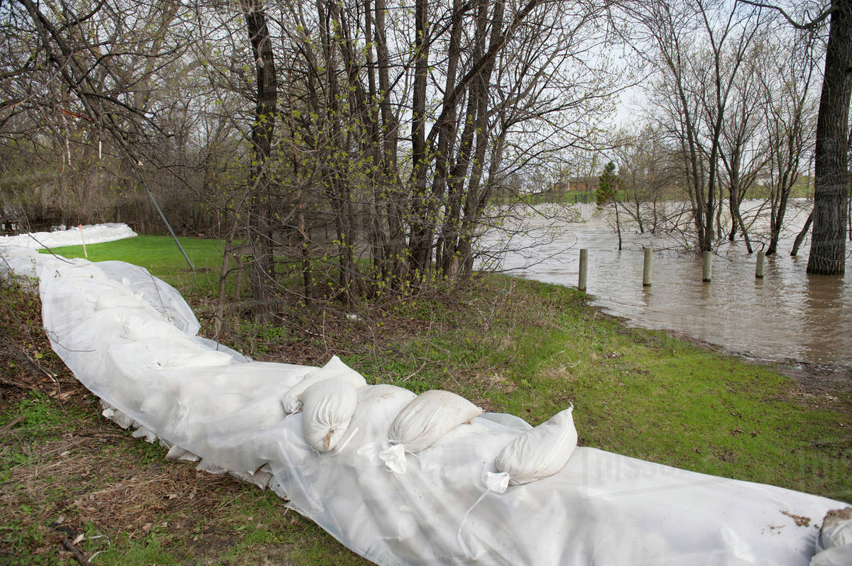 Sand Bags Line The River's Shoreline To Prevent Further Flooding; Headingley, Manitoba, Canada