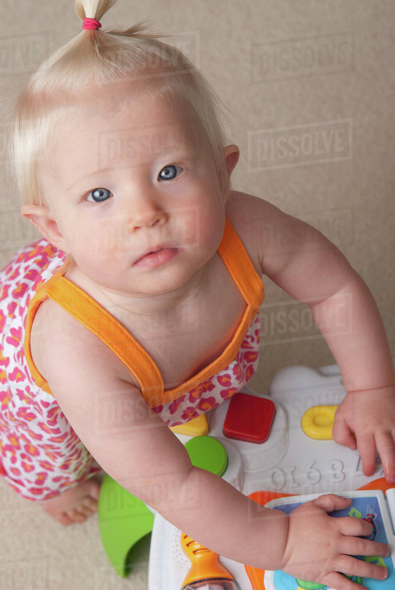 Baby Girl Playing; Millet, Alberta, Canada Stock Photo Dissolve