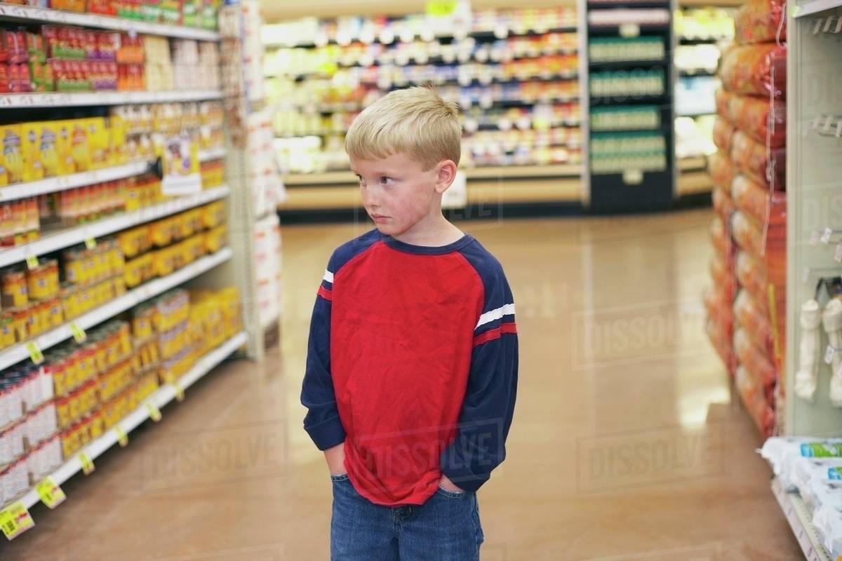 A Boy In A Grocery Store Stock Photo Dissolve