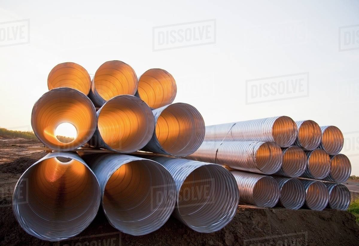 Stack Of Culvert Pipes; Edmonton, Alberta, Canada Stock Photo Dissolve