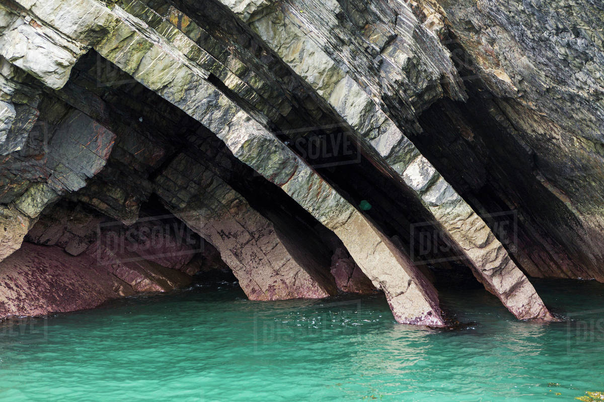 Close up of curved bedding planes of rock at water's edge; County Clare