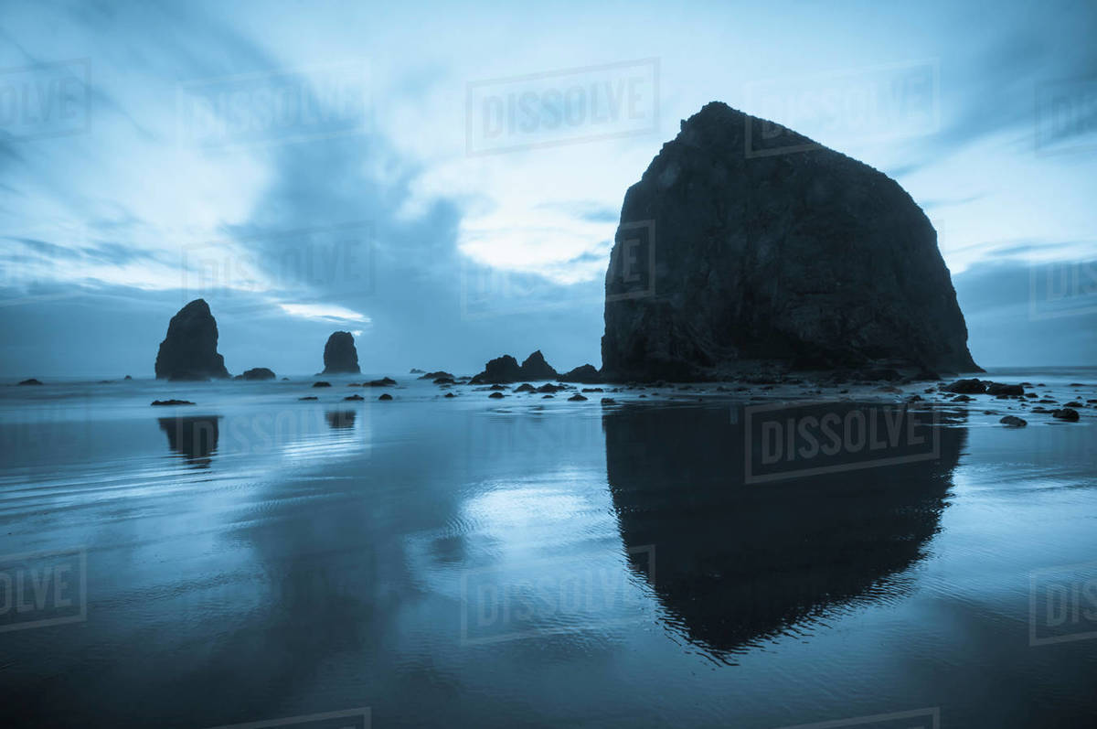 Greyish Blue Colors Of Dusk Behind Haystack Rock; Cannon Beach, Oregon