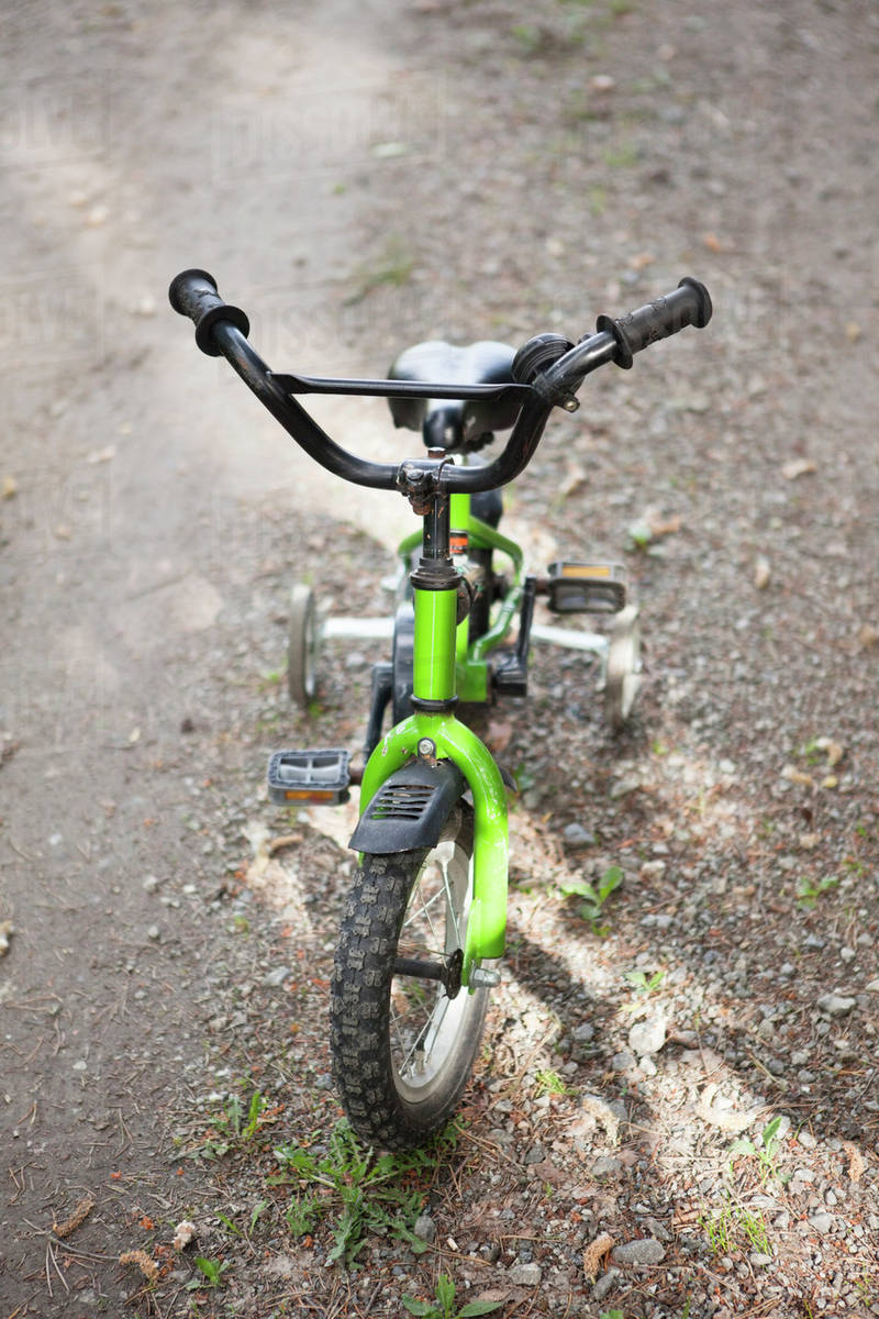 Children's bike with training wheels Stock Photo Dissolve