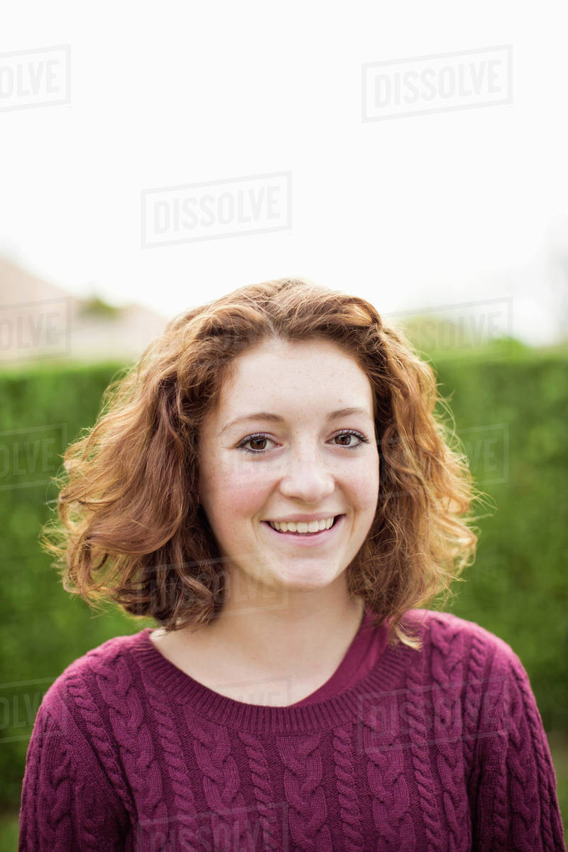Portrait of happy young girl in sweater Stock Photo Dissolve