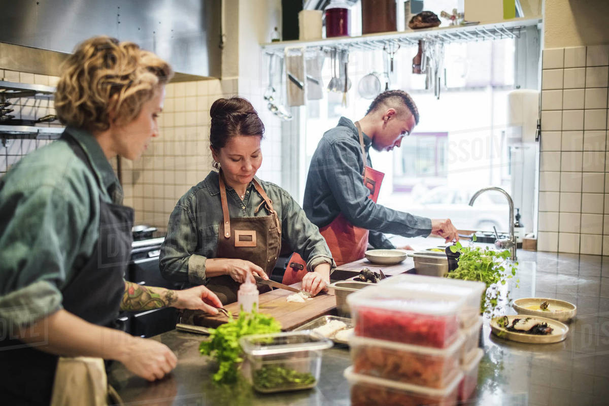 Multiethnic chefs preparing food at kitchen counter in restaurant
