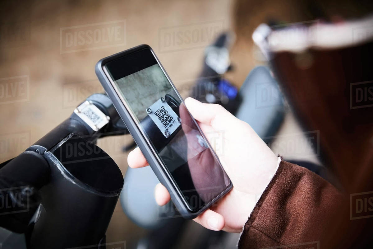 Cropped image of teenage boy using mobile phone over electric push scooter Royalty-free stock photo