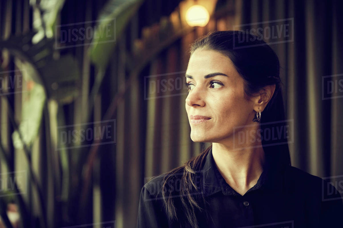 Confident female owner looking away while standing in cafe Royalty-free stock photo