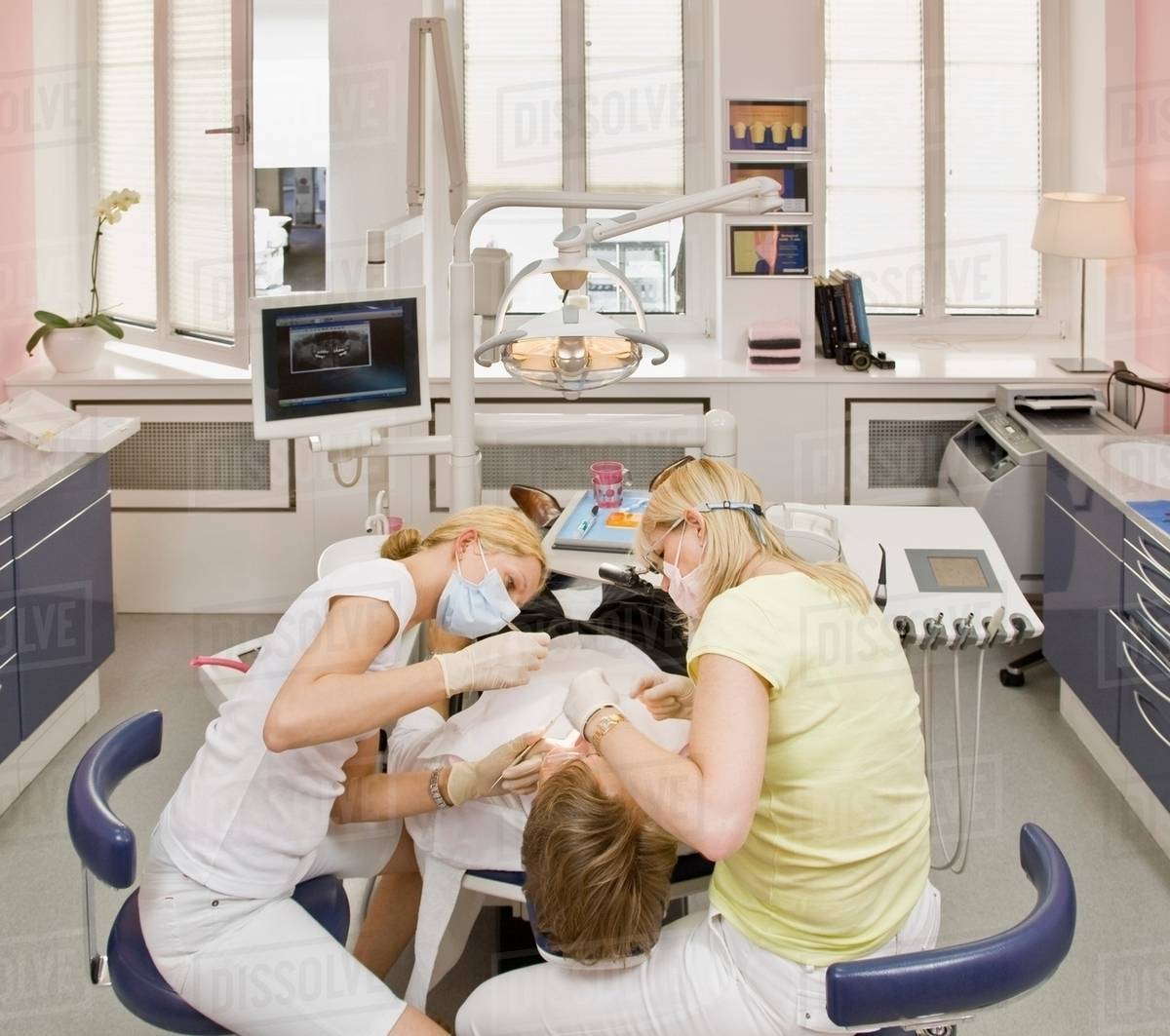Female dentist working on a male patient Stock Photo Dissolve