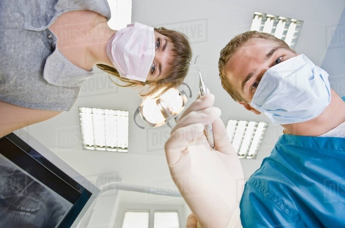 Dentist with dental tools and assistant Stock Photo Dissolve