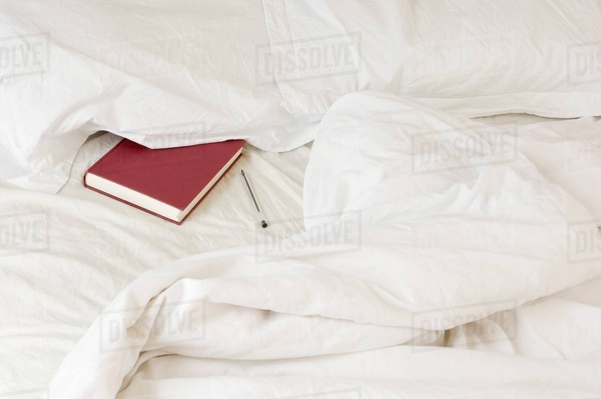 Diary tucked under pillow Stock Photo Dissolve