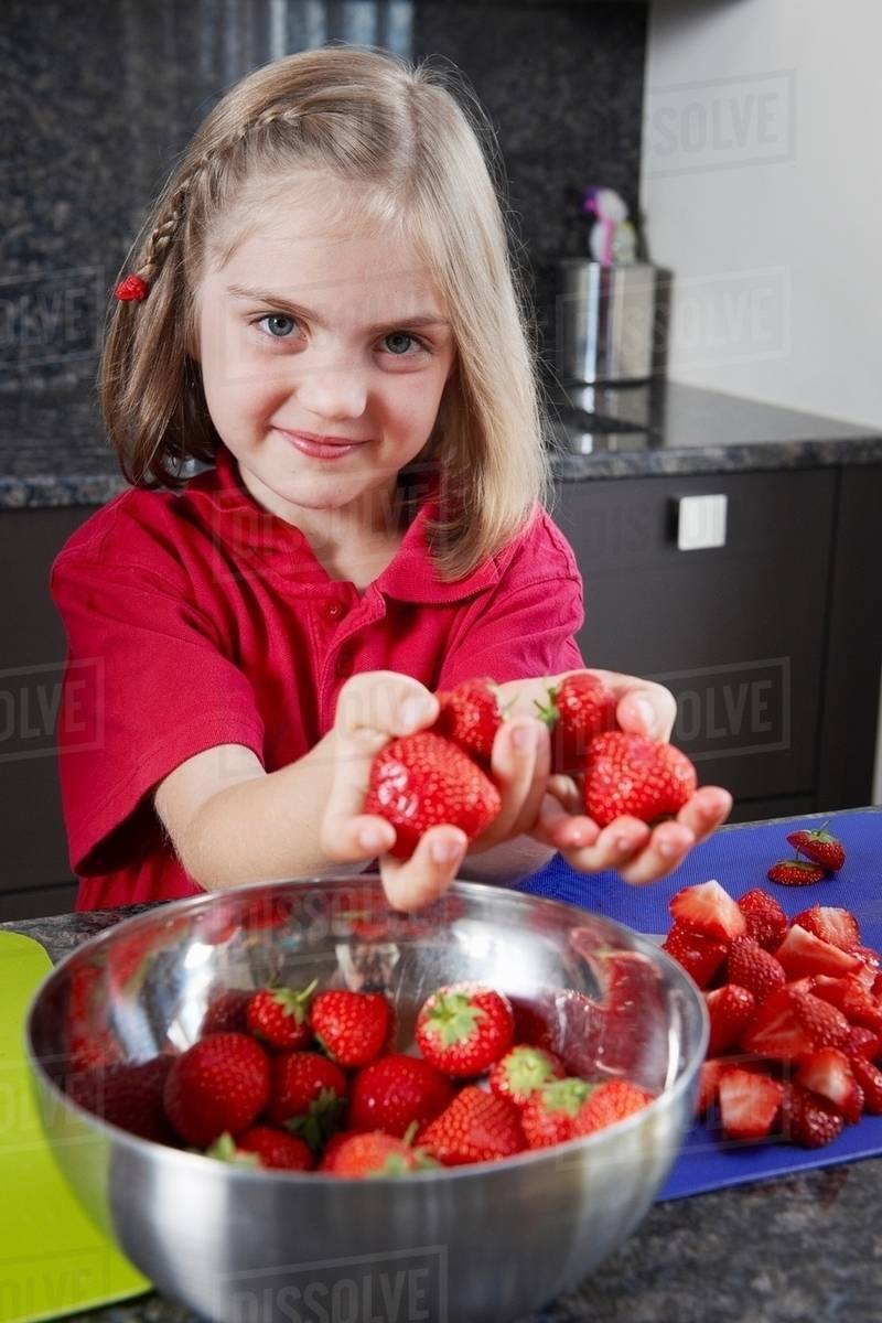 Girl preparing strawberries Stock Photo Dissolve