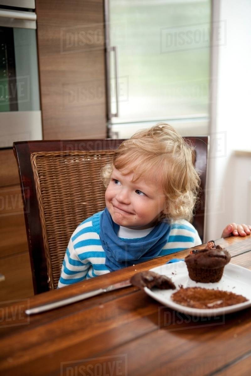 Child eating muffin Stock Photo Dissolve