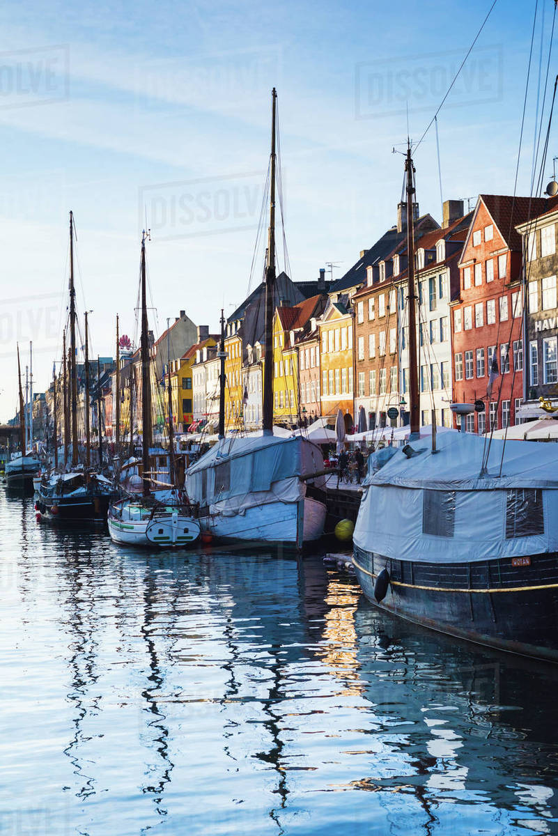 Traditional multicoloured townhouses and moored boats on canal