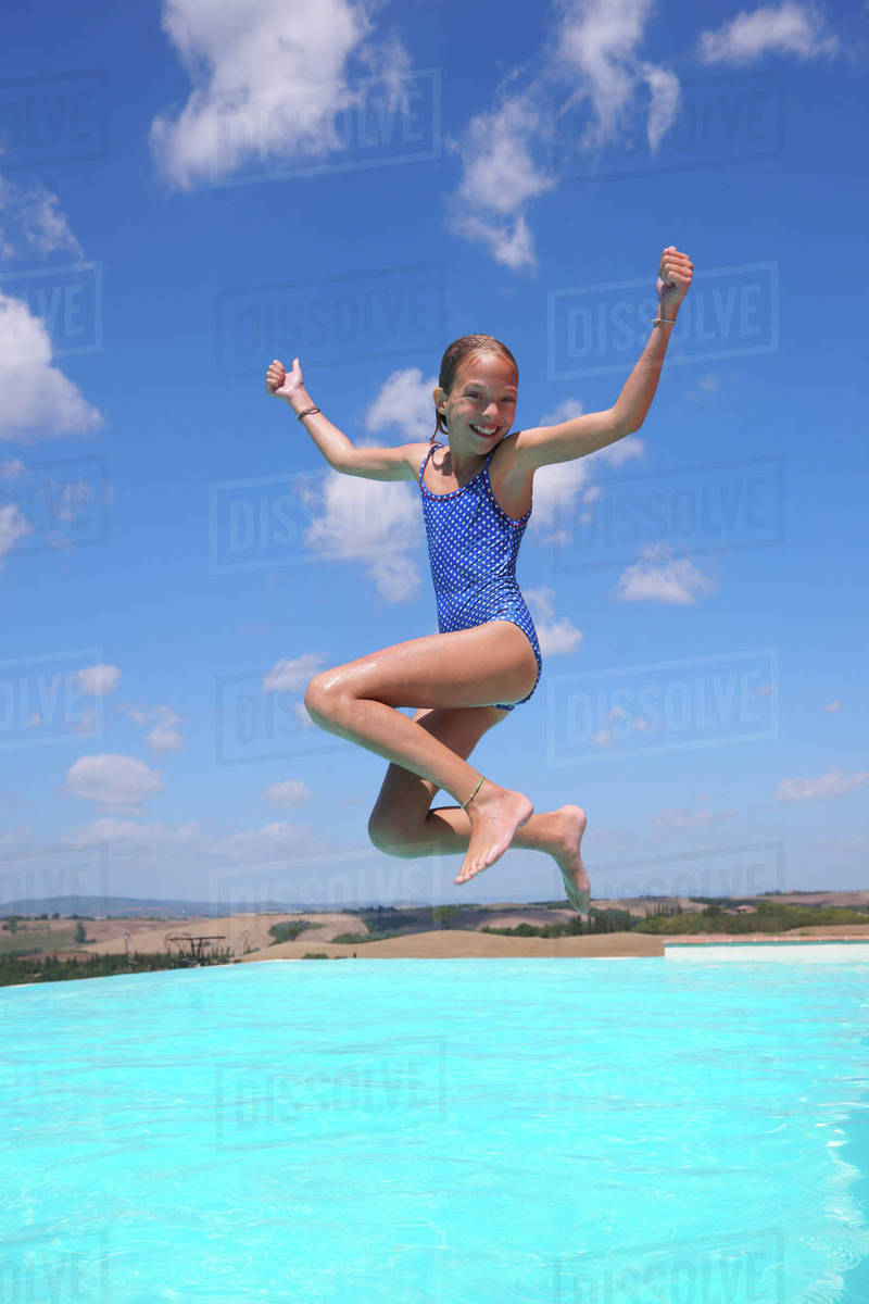 Girl jumping into swimming pool, Buonconvento, Tuscany, Italy Royalty-free stock photo