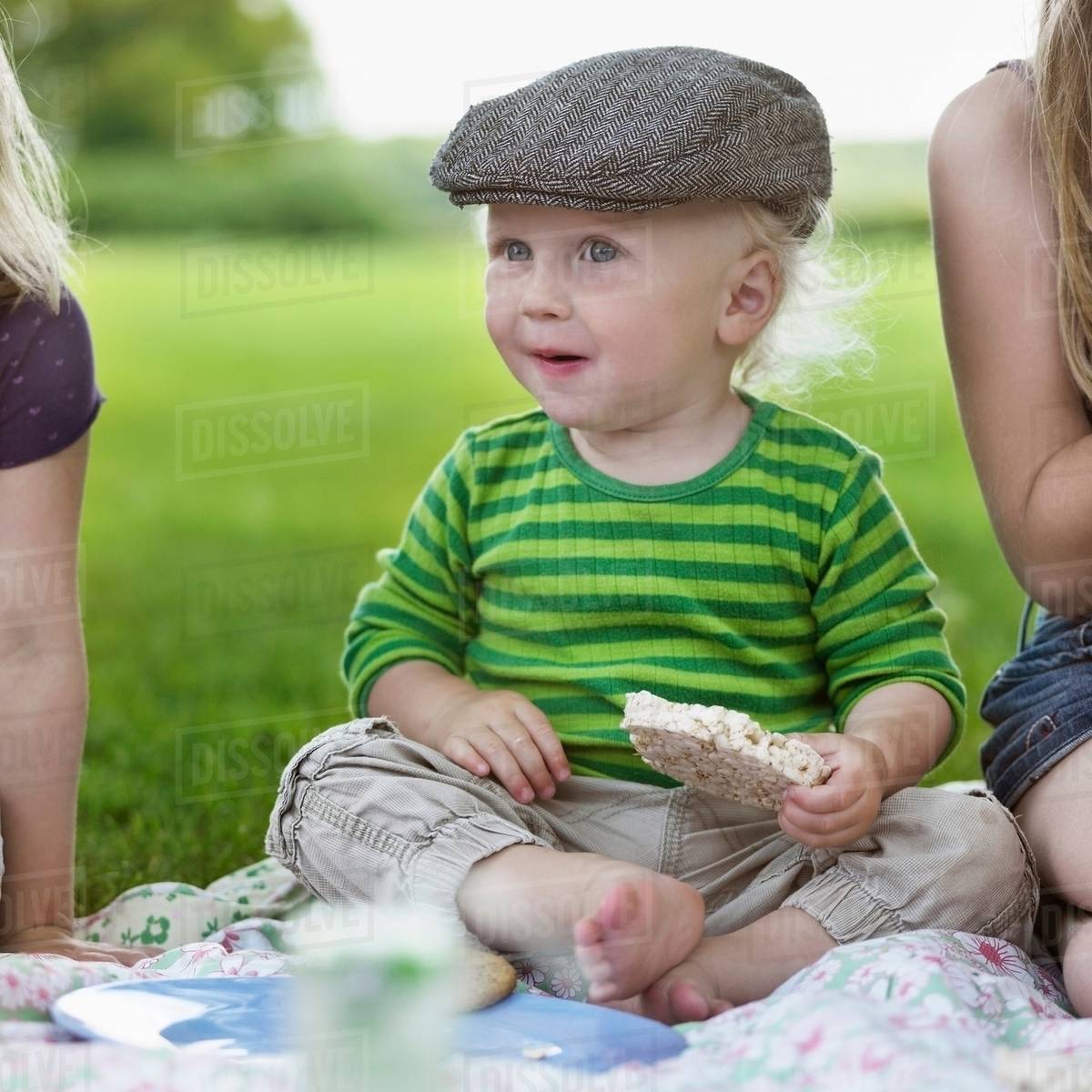 Boy eating rice cake at picnic Stock Photo Dissolve