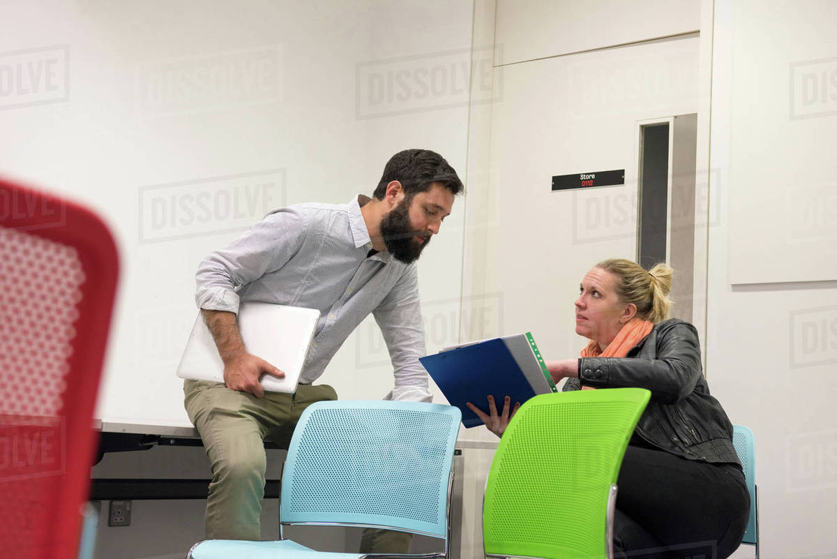 Male and female students comparing notes - Royalty-free Stock Photo ...