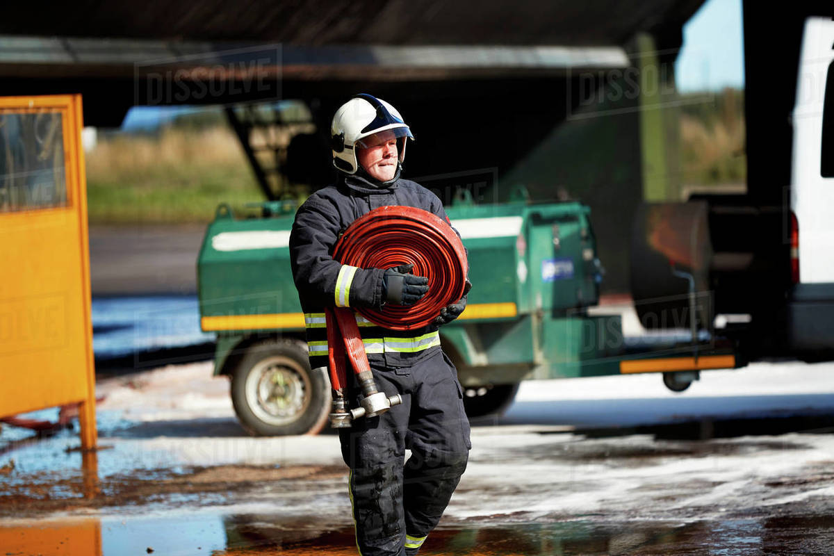 Fireman carrying fire hose reel, Darlington, UK - Royalty-free Stock ...
