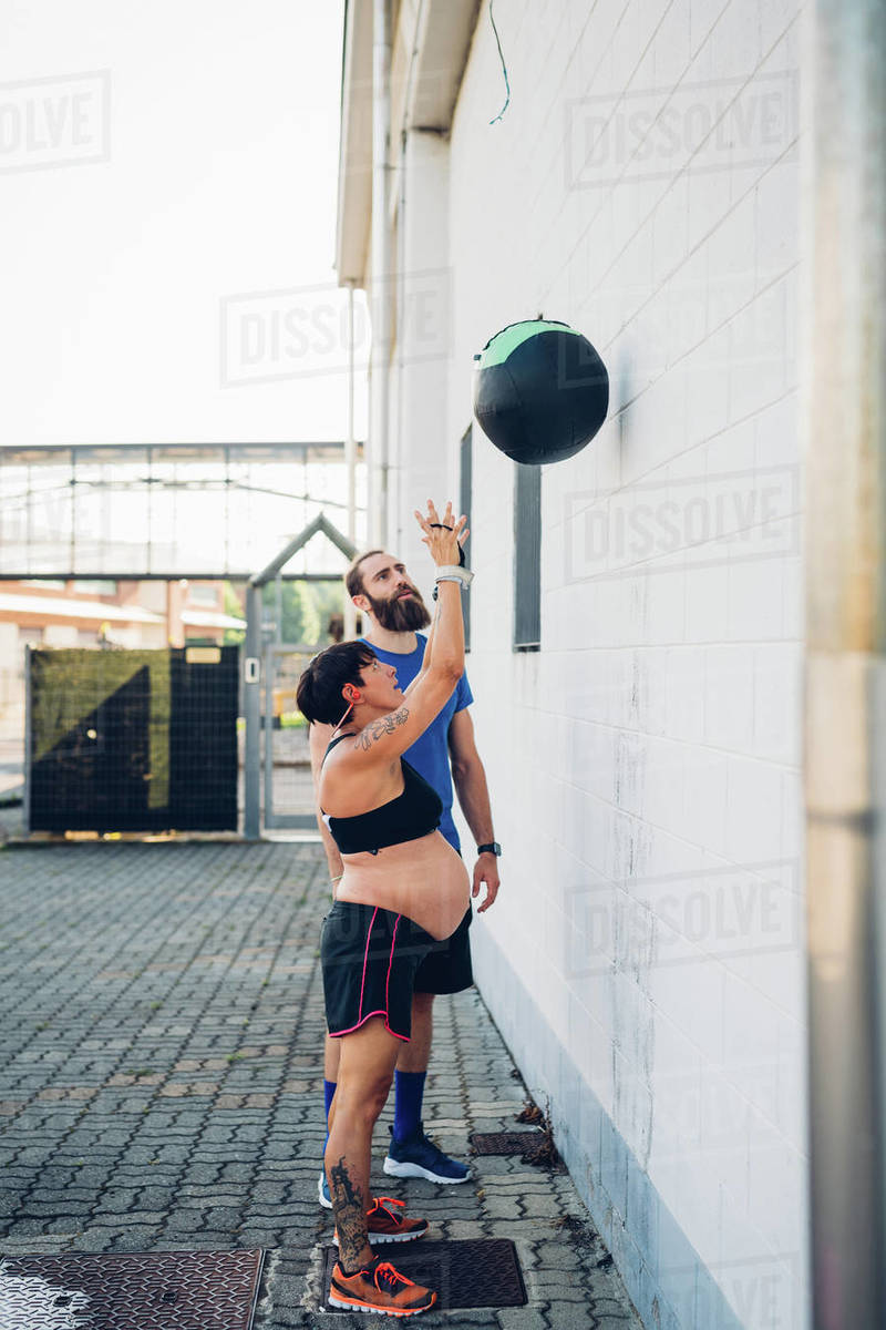 Pregnant woman throwing exercise ball Stock Photo Dissolve