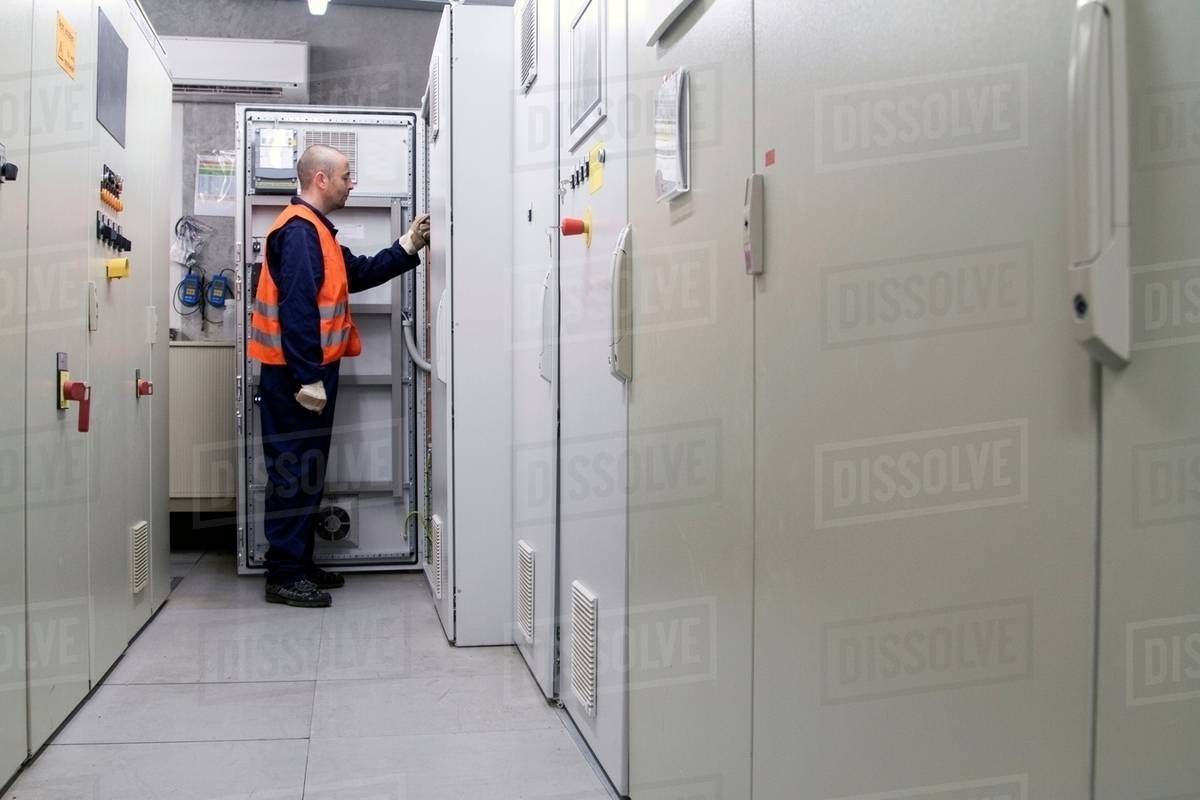 Technician doing a check in power station control room - Royalty-free ...