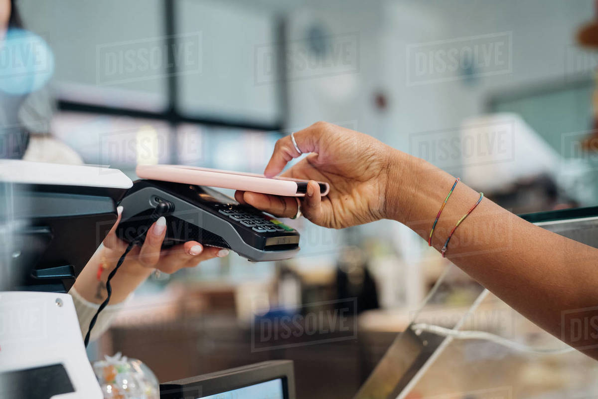 Young businesswoman making smartphone payment at cafe counter, cropped Royalty-free stock photo