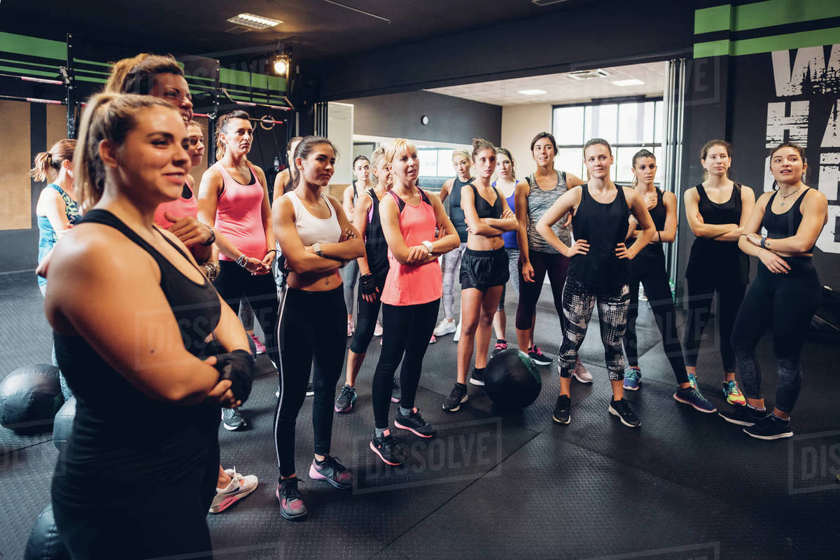 Large group of women training in gym, listening Stock Photo Dissolve