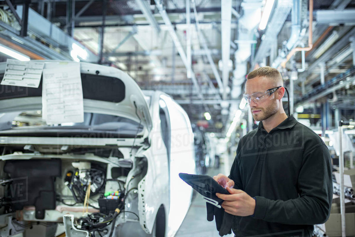 Engineer with digital tablet on production line in car factory Royalty-free stock photo